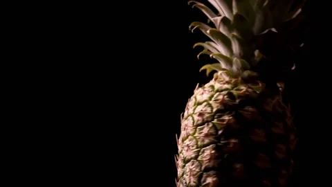 Fresh pineapple on black background. Rotating fruits on black background Video stock 150061799