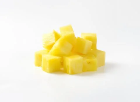 Fresh pineapple chunks on clean surface Stock Photos