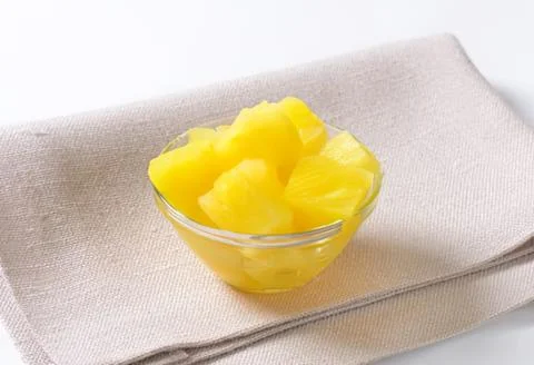 Fresh pineapple chunks in a clear bowl Stock Photos