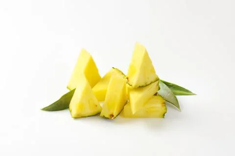 Fresh pineapple chunks with green leaves Stock Photos