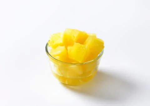 Fresh pineapple chunks in a small glass bowl Stock Photos