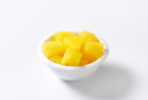 Fresh pineapple chunks in a white bowl Stock Photos