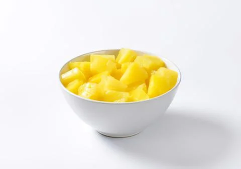 Fresh pineapple chunks in a white bowl Stock Photos
