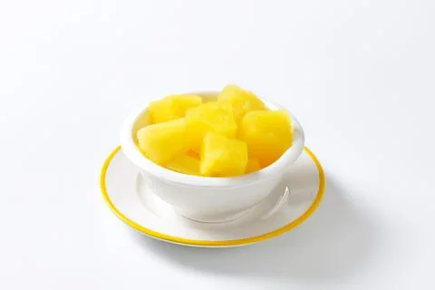 Fresh pineapple chunks in a white bowl Stock Photos