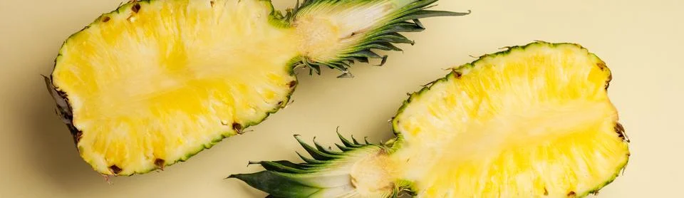 Fresh pineapple cut in two part and paper frame on yellow background. Summer  Stock Photos