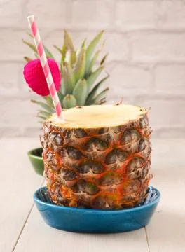Fresh pineapple with a drinking straw Stock Photos