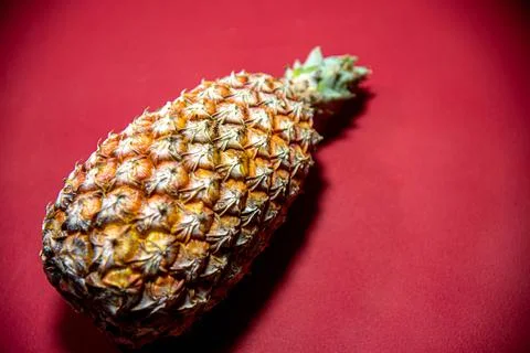 Fresh pineapple fruit on red background Stock Photos