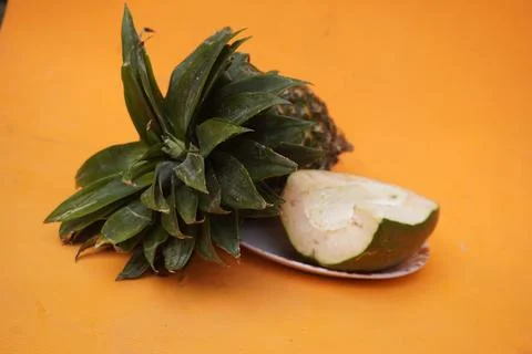 Fresh pineapple fruit with a refreshing smoothie, vibrant tropical drink 库存照片