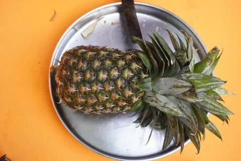 Fresh pineapple fruit with a refreshing smoothie, vibrant tropical drink Фото
