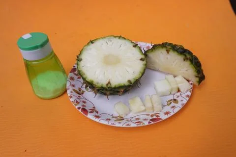 Fresh pineapple fruit with a refreshing smoothie, vibrant tropical drink 库存照片