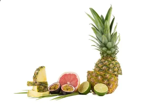 Fresh pineapple, grapefruit, lime, and passion fruit on white 写真素材