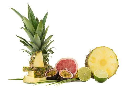 Fresh pineapple, grapefruit, passion fruit, and lime on white 写真素材
