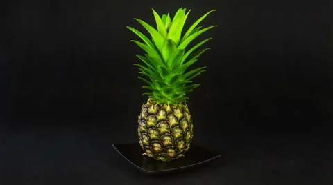 Fresh pineapple rotation on a black background, 4K Stock Footage 47430384