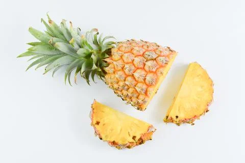 Fresh pineapple slices over white background. Tropical fruit. Stock Photos
