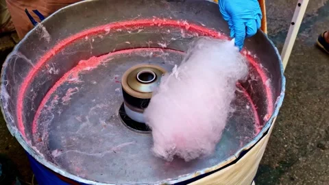 Fresh pink cotton candy spun inside a traditional sugar machine Stock Footage 315840217