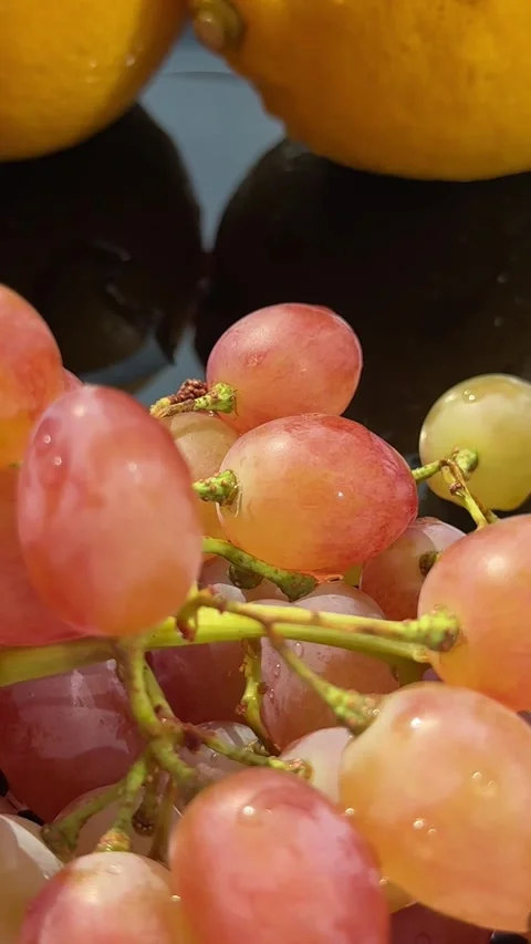 Fresh pink grapes Grapes fall on a cutting board with splashes of water. On a Stock Footage 317722415