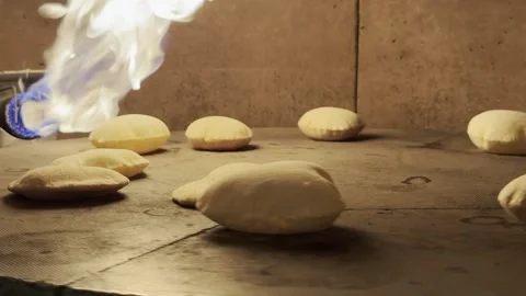 Fresh Pita Bread Inflating in Stone Oven Industrial with Burning Flame Stock Footage 333726052