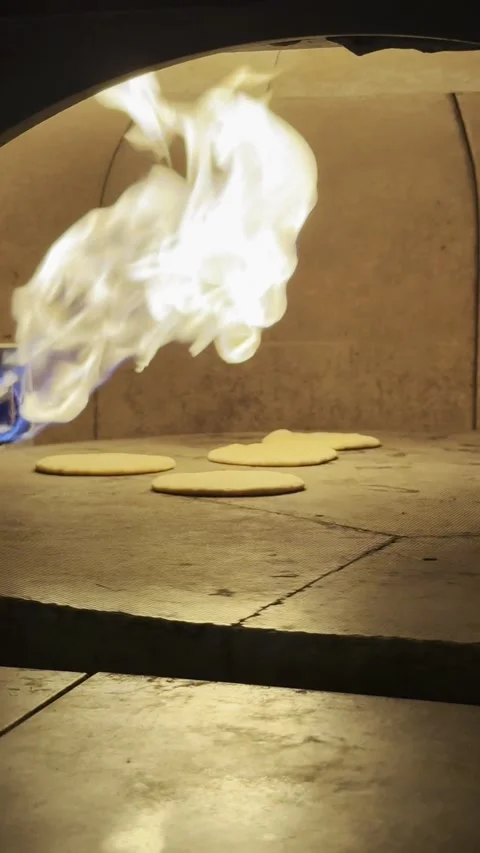 Fresh Pita Bread Inflating in Stone Oven Industrial with Burning Flame Stock Footage 333726054