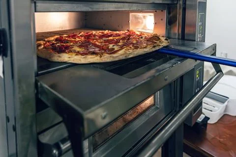 Fresh pizza baking Stock Photos