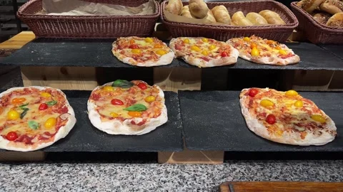 Fresh pizzas Margeritas with tomatoes, basil and Mozzarella cheese baked Stock Footage 288575157