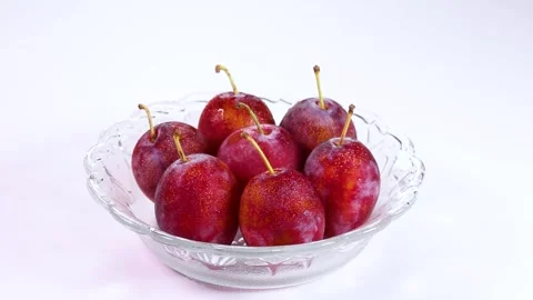 Fresh plums on a glassware, rotating Stock Footage 317922812