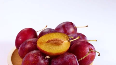 Fresh plums on a plate, rotating Stock Footage 317922846