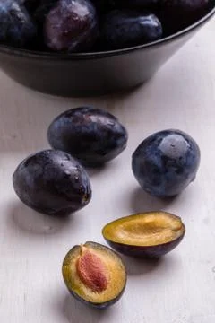 Fresh plums on white table Stock Photos