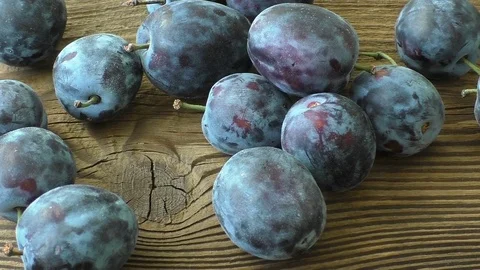 Fresh plums on wooden table Stock Footage 80639845