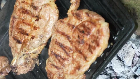 Fresh pork meat on the grill close up hand held video Stock-Footage 244742388