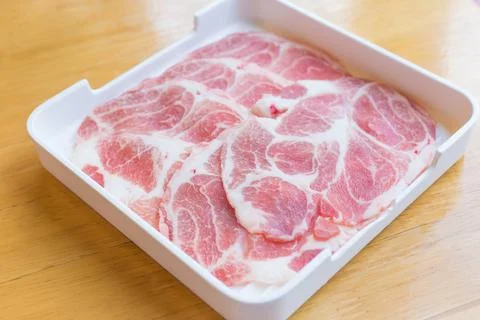 Fresh pork neck sliced raw or collar pork on board with ingredients for marin Stock Photos