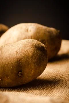 Fresh Potatoes on a rag Stock Photos