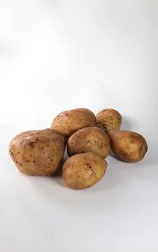 Fresh potatoes on a white background Stock Photos