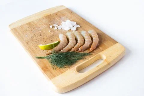 Fresh prawns on a chopping Board with lime and urope. Fresh healthy foods Stock Photos