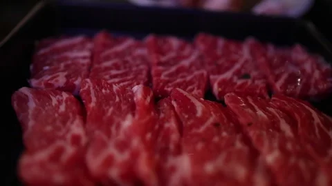 Fresh premium raw wagyu beef slices with marble texture on black plate at y.. Stock Footage 333835217