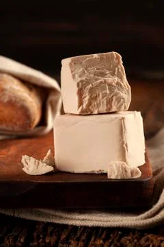 Fresh pressed yeast cubes. Stock Photos
