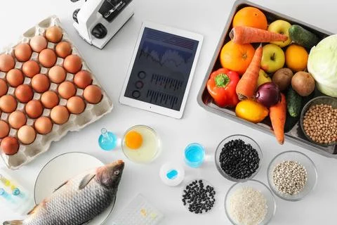 Fresh products and tablet computer on white background. HACCP concept Stock Photos