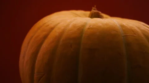 Fresh Pumpkin on table. Smooth rotation. Dark room space Stock Footage 138787696