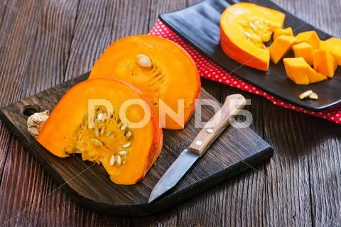 Fresh pumpkin on wooden board on a table Stock Photos