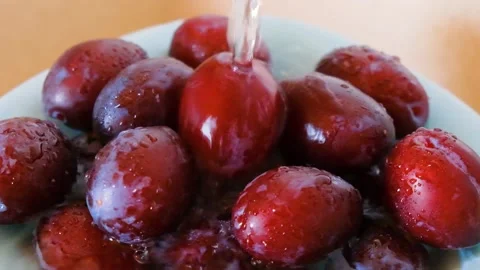 Fresh purple plums in plates Stock Footage 137010621