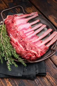 Fresh rack of lamb, raw mutton meat for chops steaks on steel tray. wooden .. Stock Photos