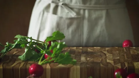 Fresh Radish Falling on Cutting Board Stock Footage 334515936