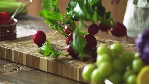 Fresh Radish Falling on Cutting Board Stock Footage 334515939