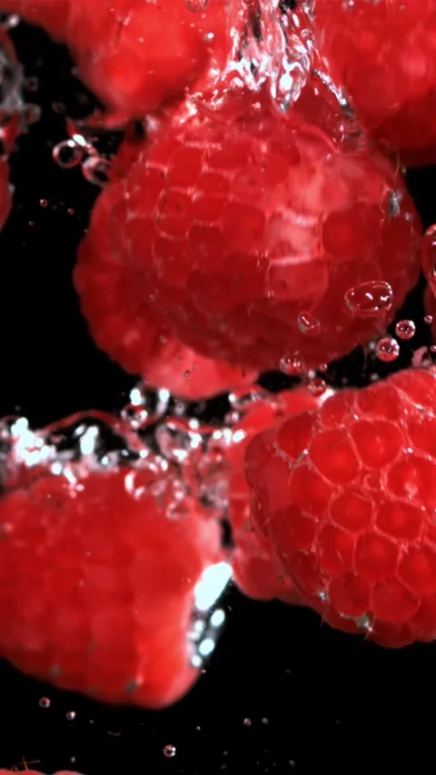 Fresh raspberries fall underwater with bubbles. Filmed is slow motion 1000 fps Stock Footage 335292088