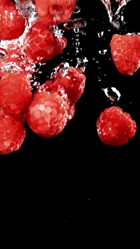 Fresh raspberries fall underwater with bubbles. Filmed is slow motion 1000 fps Stock Footage 335292143