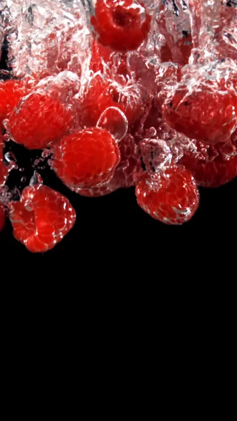 Fresh raspberries fall underwater with bubbles. Filmed is slow motion 1000 fps Stock Footage 335293179