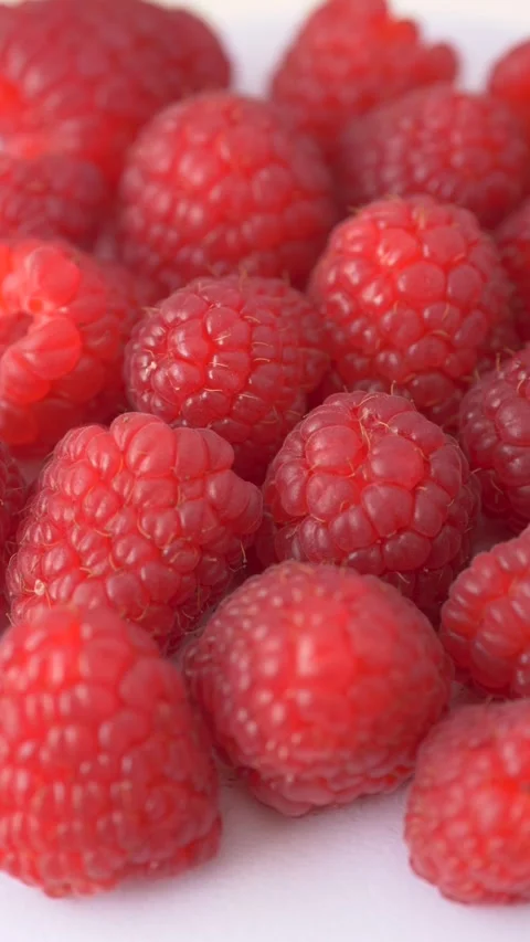 Fresh raspberries rotating on white background symbolize antioxidant nutrition Stock-Footage 333115376