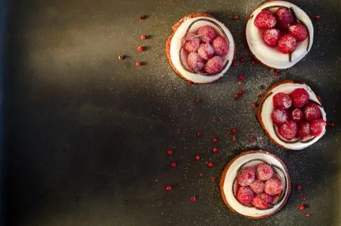 Fresh raspberry cakes, overhead view on dark border background. Free space for Stock Photos