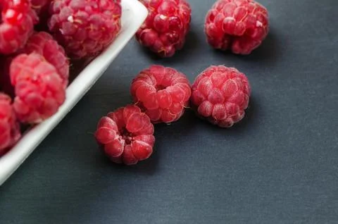 Fresh raspberry on dark stone background Stock Photos