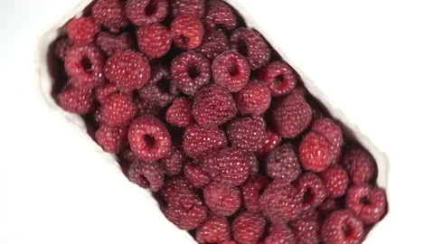 Fresh raspberry fruits rotating on white, top down view Stock Footage 94888202