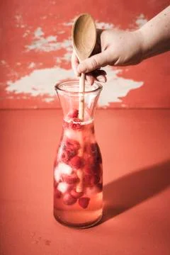 Fresh raspberry lemonade. Preparing cold summer drink Stock Photos